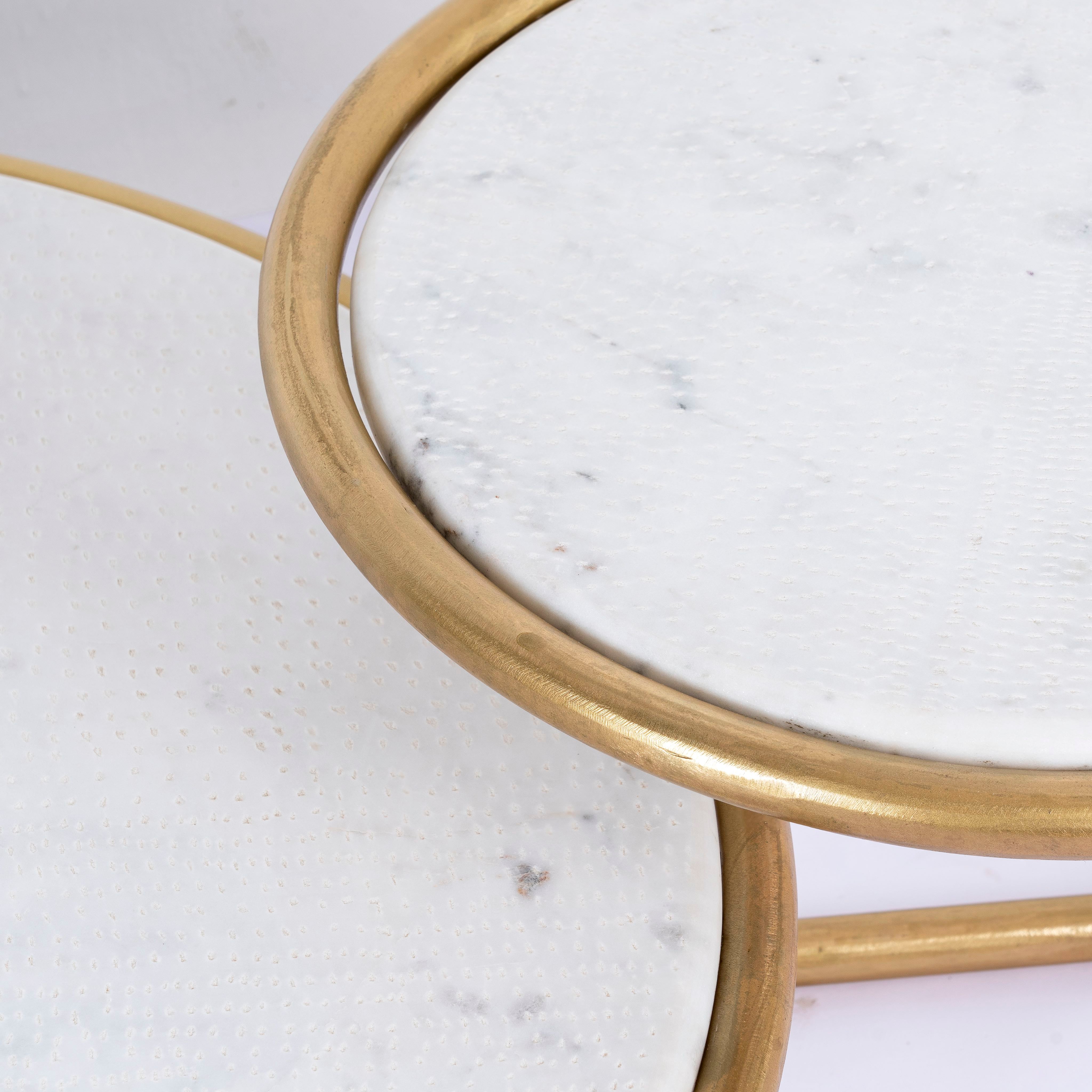 Close up image of a rectangular metal coffee table with hammered marble top and brass-plated iron base; marble top coffee table, 109 × 41 × 77 cm.