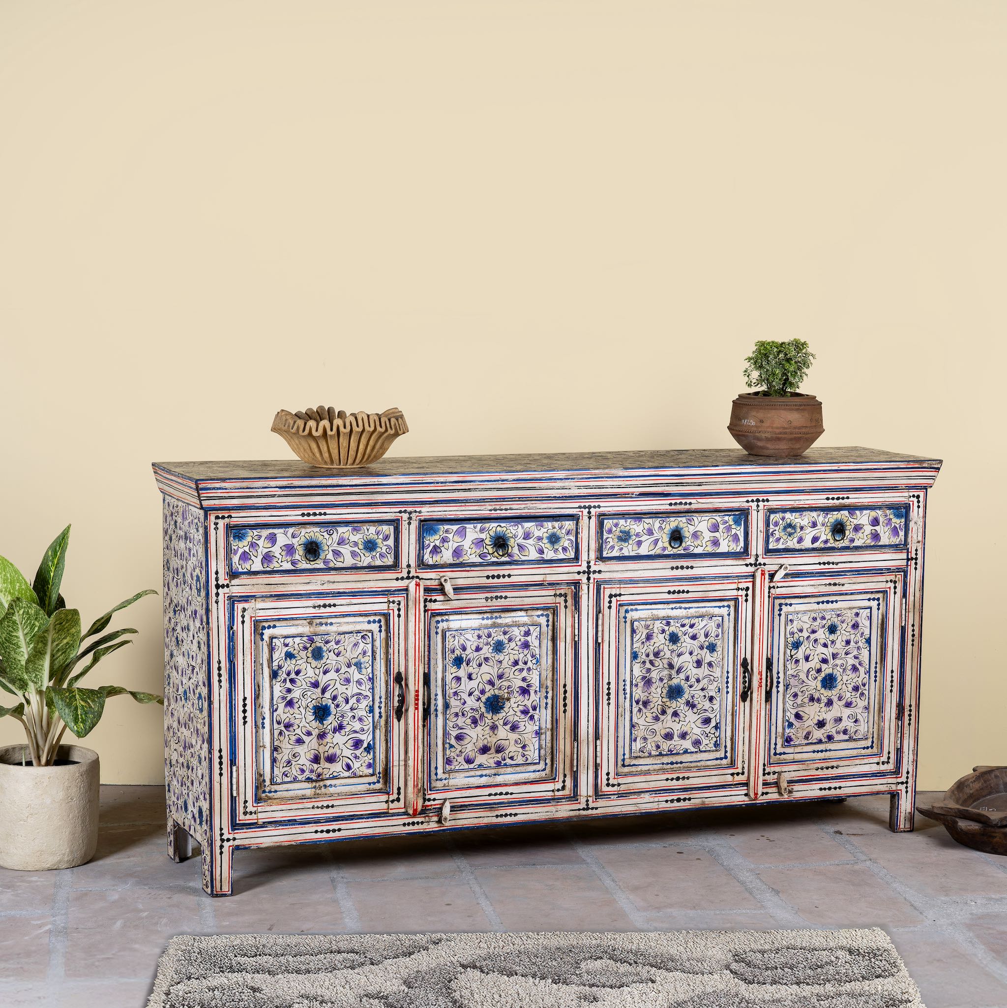 Side angle image of a hand painted wooden furniture sideboard with floral motifs, unique furniture piece made from reclaimed wood, 180 × 40 × 90 cm.