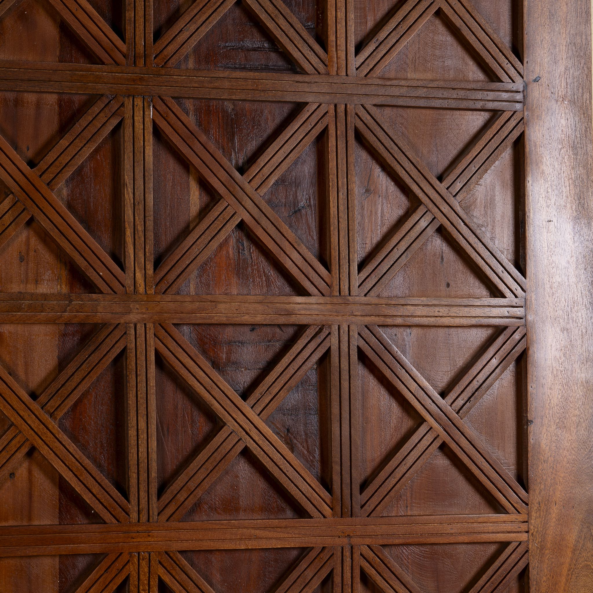 Close-up of a wooden panel with geometric lattice pattern