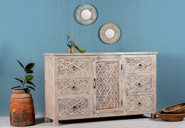 Side angle image of a hand-carved wood carved sideboard in mango wood furniture style with vintage three-layer finish.