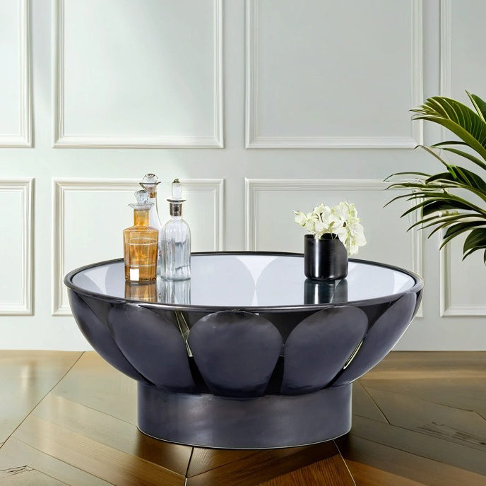 Lifestyle image of a round metal base coffee table with petal design and marble top; marble top coffee table with black wrought iron base, 87 cm diameter, 37 cm height.