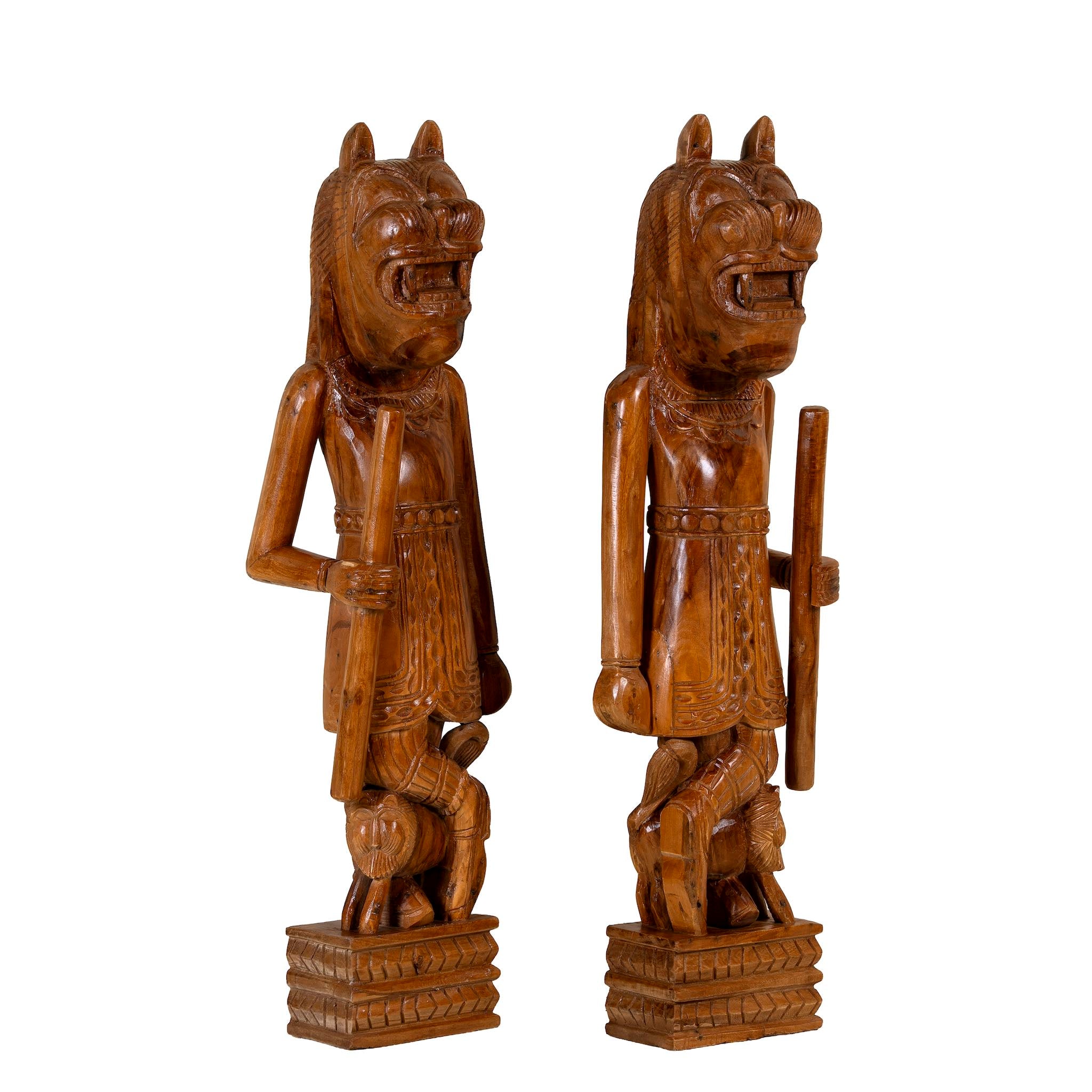 White background image of a hand-carved Indian house guardian statue in exotic style, made from reclaimed wood; sustainable furniture, 40 × 20 × 120 cm.