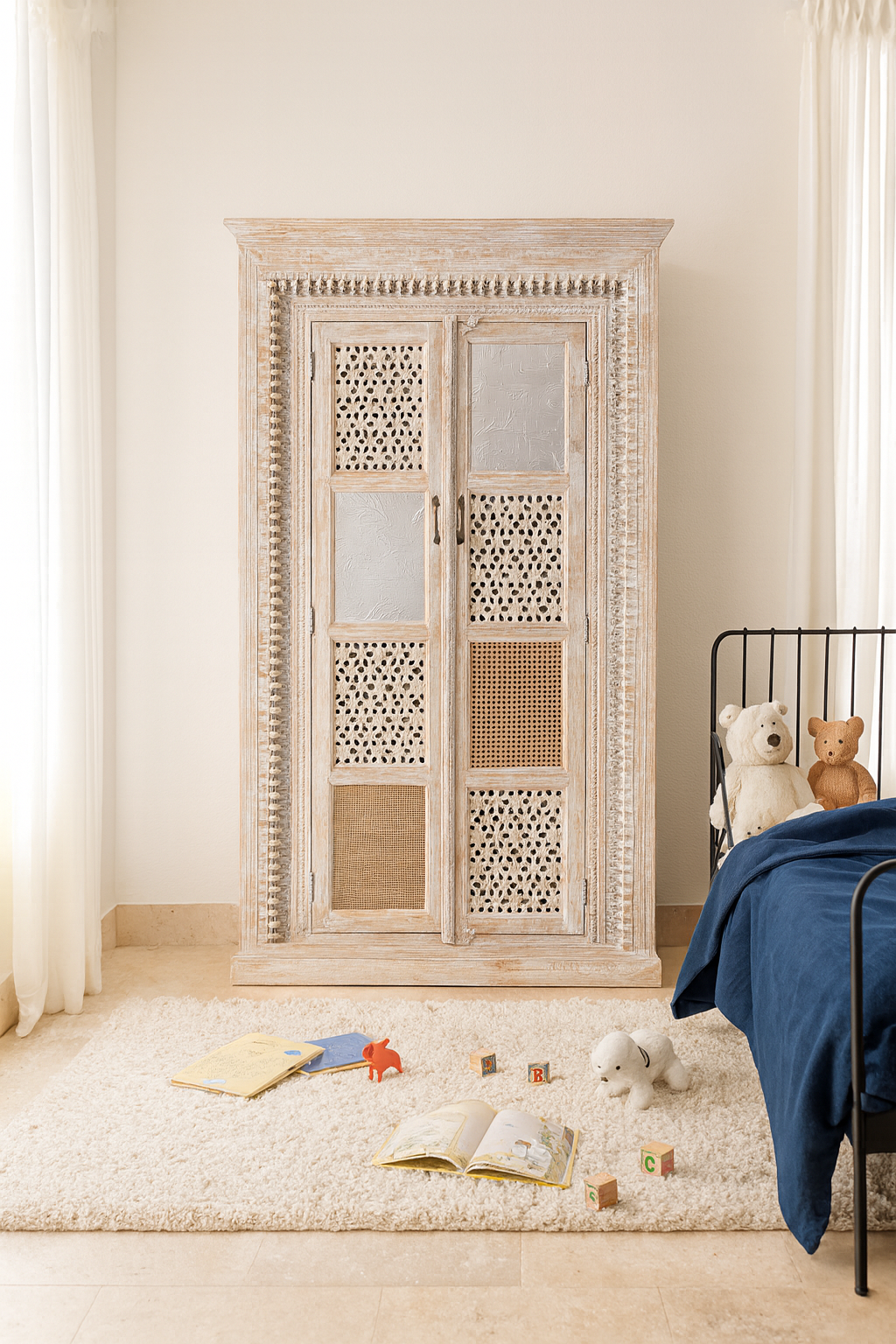 Lifestyle imagination of a whitewashed mango wood cabinet with hand-carved details, rattan inserts, and glass panels; versatile as bedroom furniture or wooden wardrobe; 192 × 110 × 40 cm.