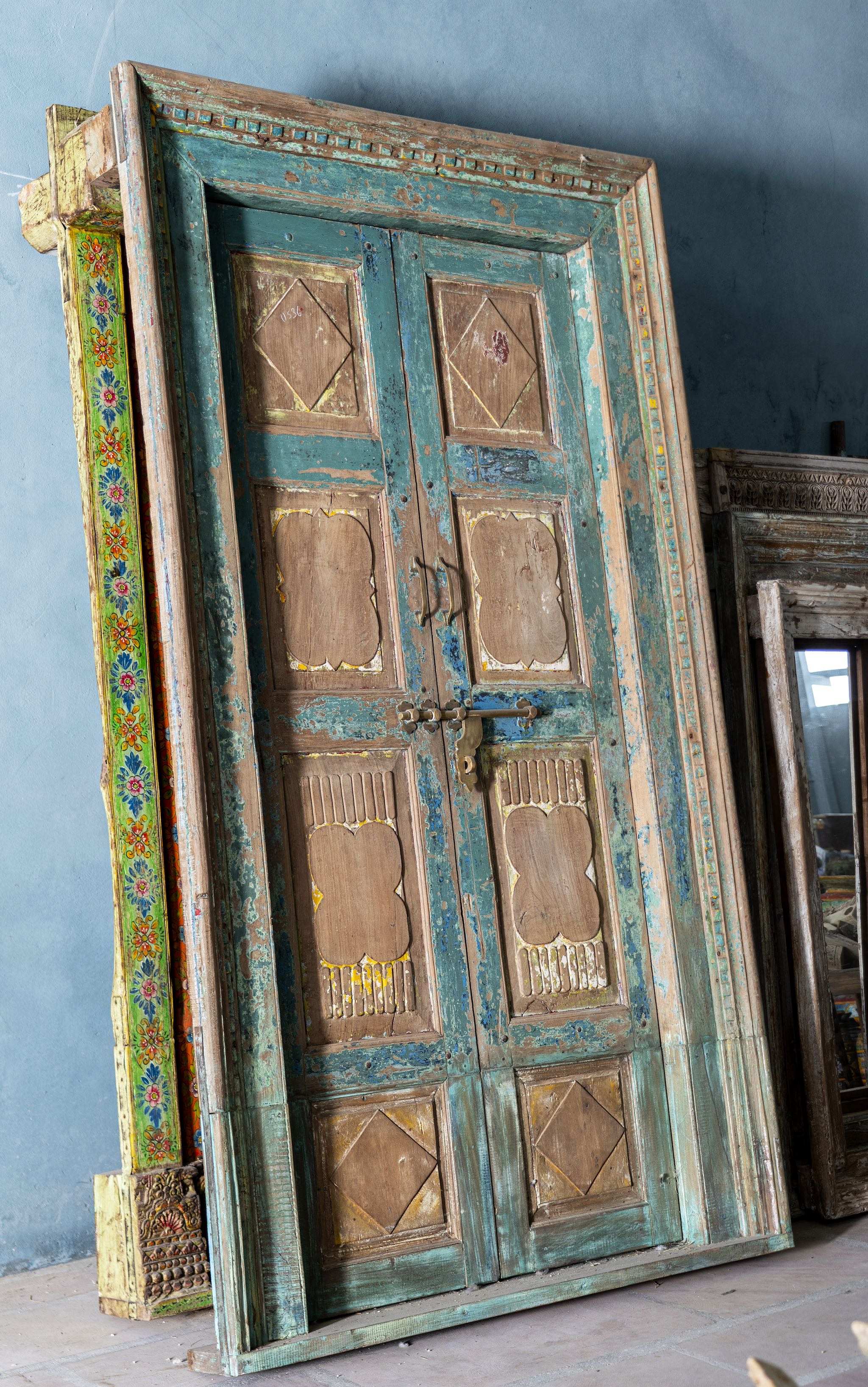 Antique Indian teak wood door with turquoise patina, golden accents, and brass hardware, vintage wall panels and vintage home decor.