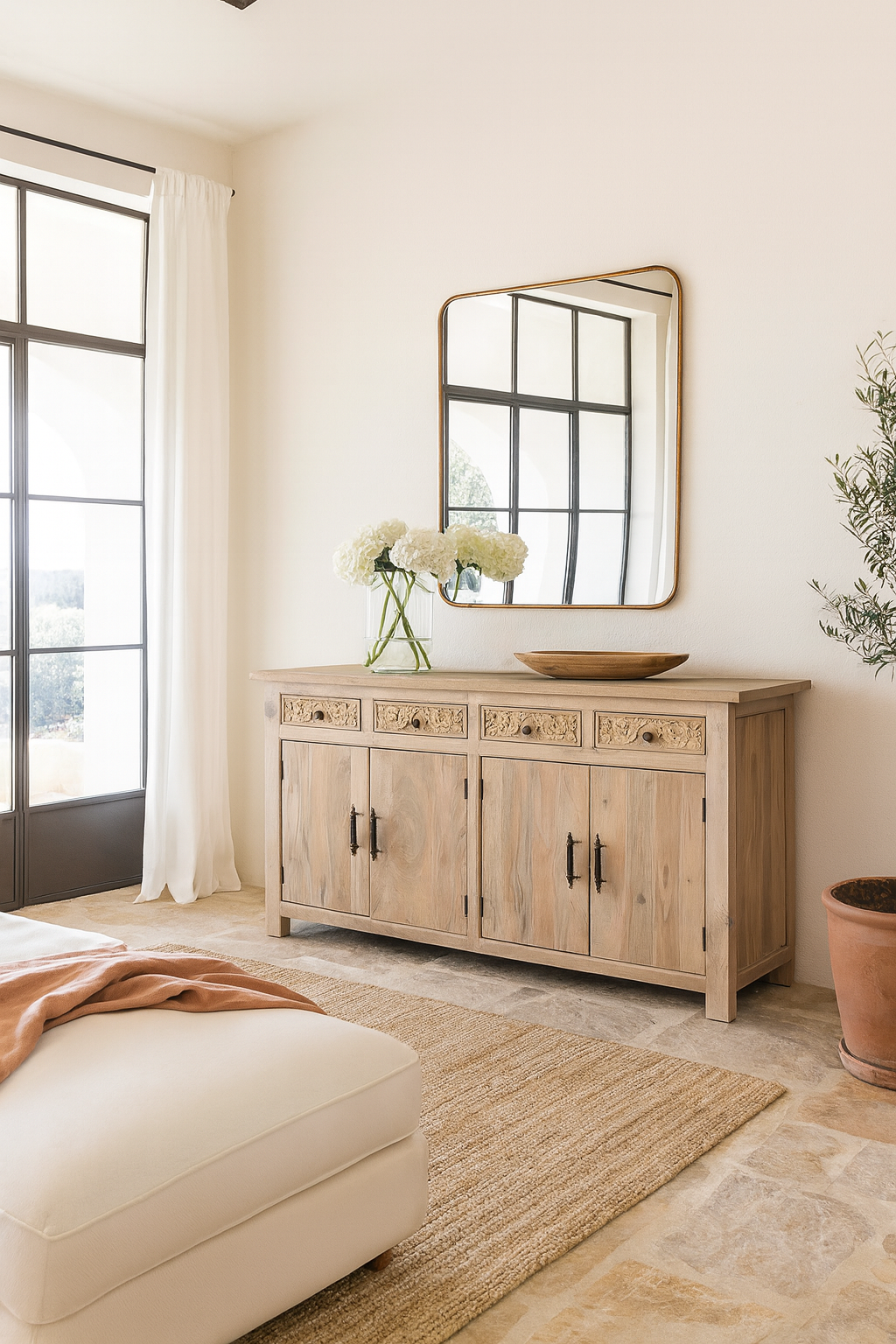 Lifestyle scene with a hand-carved mango wood sideboard with sandblasted finish – a rustic mango wood furniture piece ideal for Ibiza style interiors.