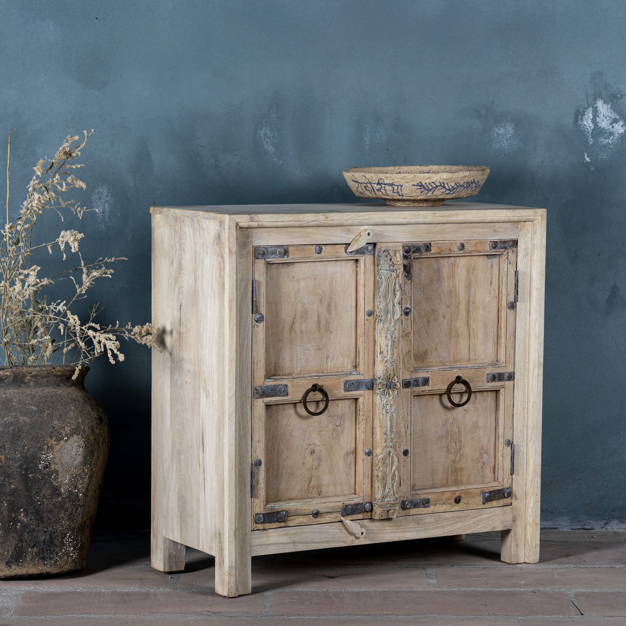 Side view of a unique old Door cupboard finely hand carved in bleached teak wood, driftwood design with iron fittings.