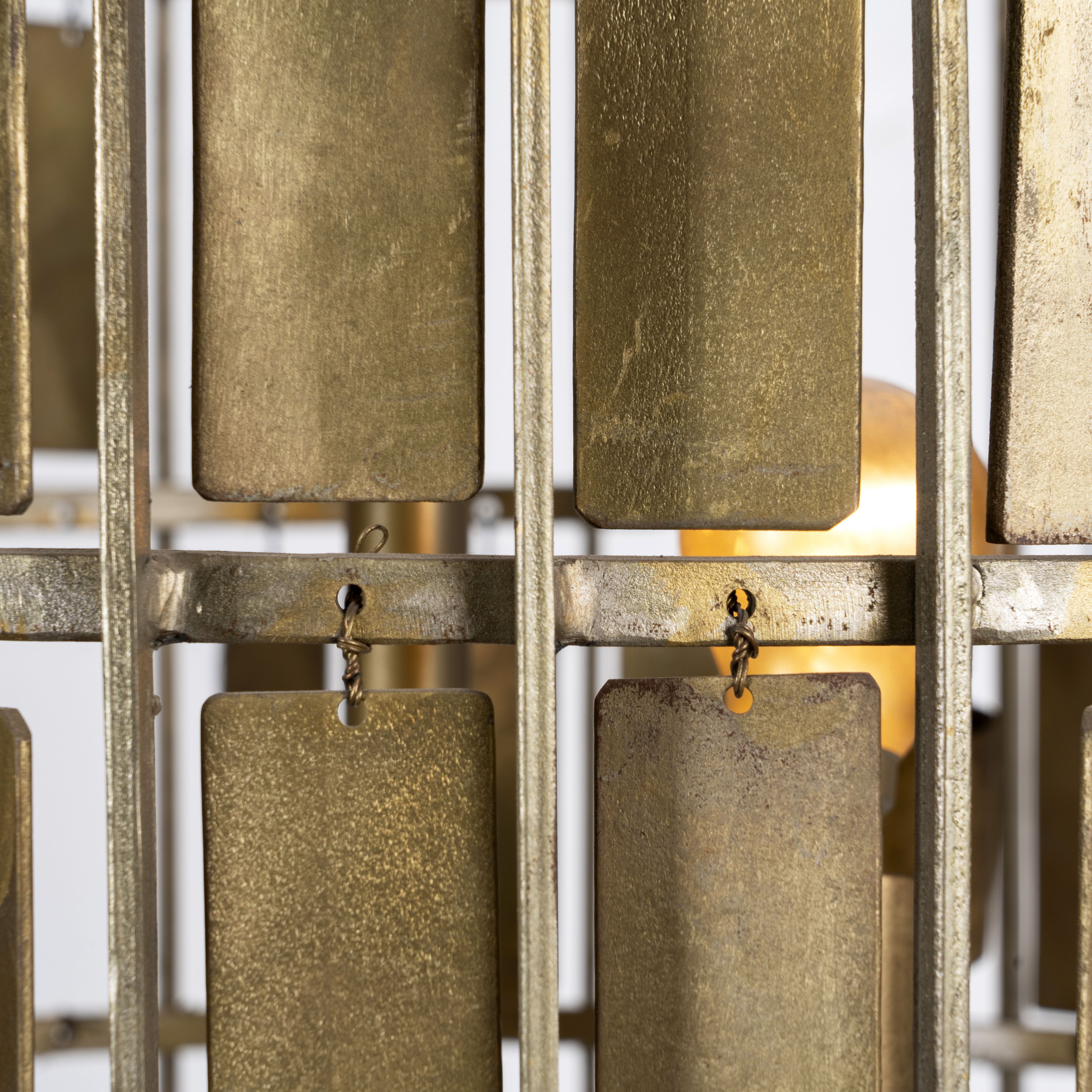 Close up image of a large round brass-plated iron pendant lamp with ornate tile surface – vintage lighting and iron pendant light ideal for dining rooms or living spaces.