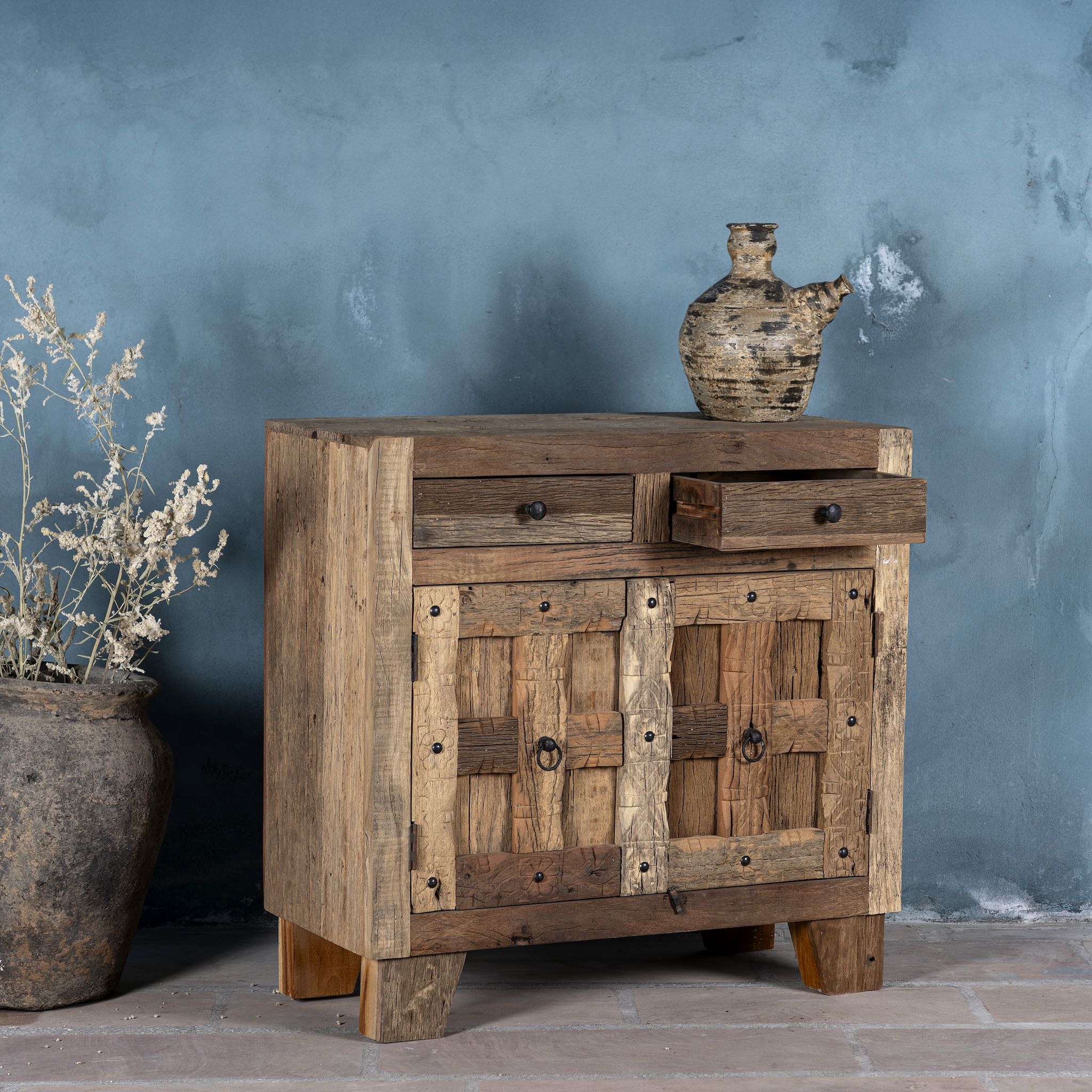 Side view of a driftwood cabinet made from reclaimed wood with panelled doors, drawers, and rustic finish, 90 × 40 × 90 cm.