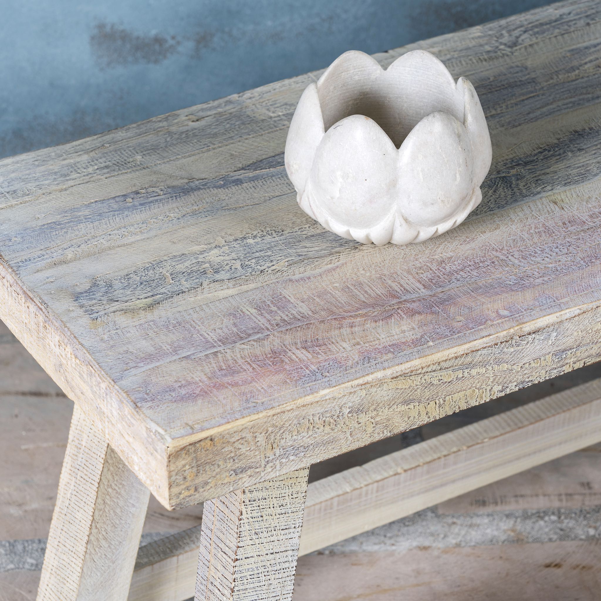 Close up image of a sandblasted driftwood bench made of reclaimed wood, sustainable furniture with rustic design, 120 × 36 × 50 cm.