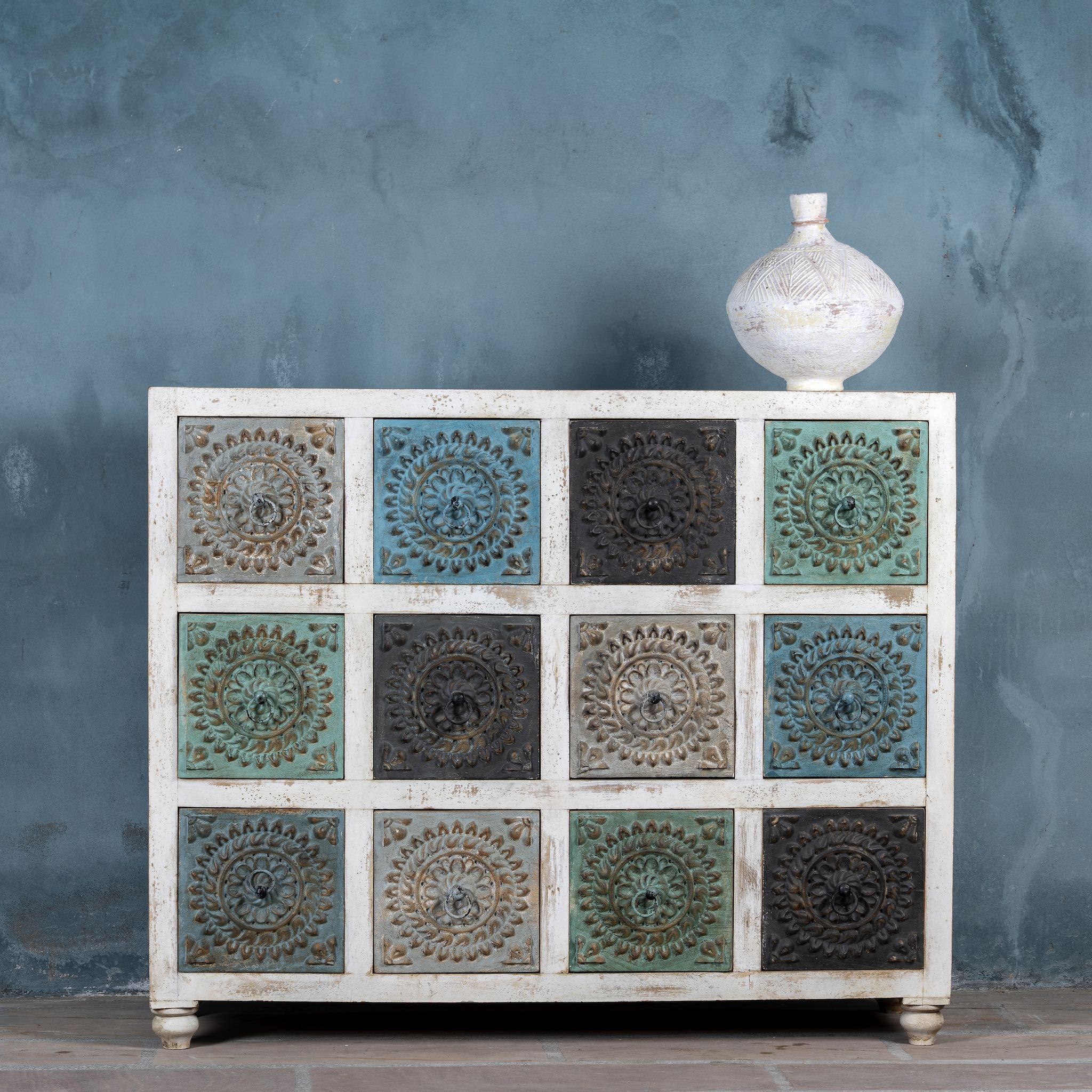 Carved mango wood chest of drawers with twelve multicolour floral drawer fronts, 124 × 40 × 102 cm.