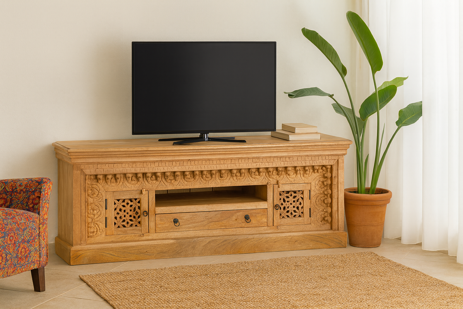 Lifestyle imagination of a carved mango wood TV unit with hand-carved doors, one drawer, and open shelf, 150 × 60 × 40 cm.