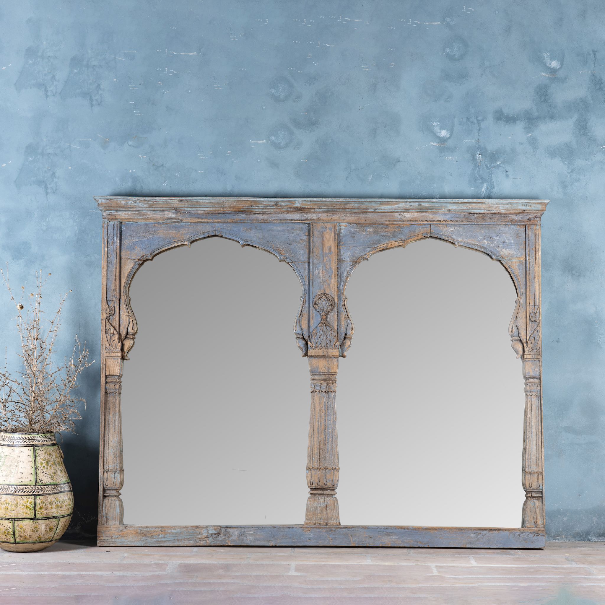Indian triple-arched teak wall mirror with indigo patina, perfect for vintage home decor or a boho chic living room.