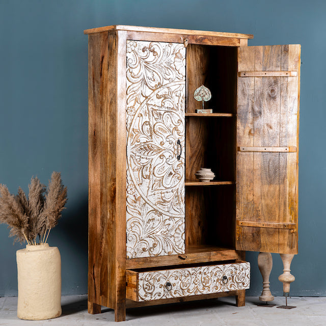 Sde angle image with open doors of a hand-carved mango wood wardrobe with whitewashed floral motifs – Zashil by Om Home & Garden, a Mediterranean-inspired piece of carved wooden furniture.