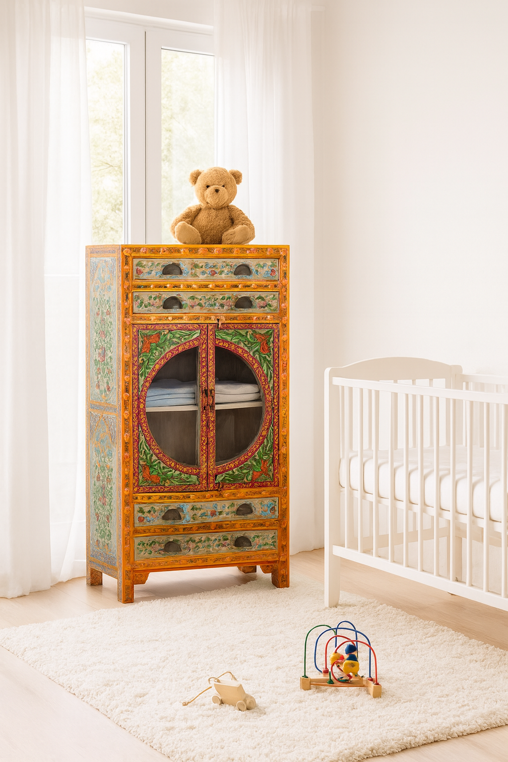 Lifestyle imagination of a hand-painted showcase cabinet made from mango wood, featuring a circular glass-front display, floral motifs in rich orange, green, and red tones, and five drawers for added storage.