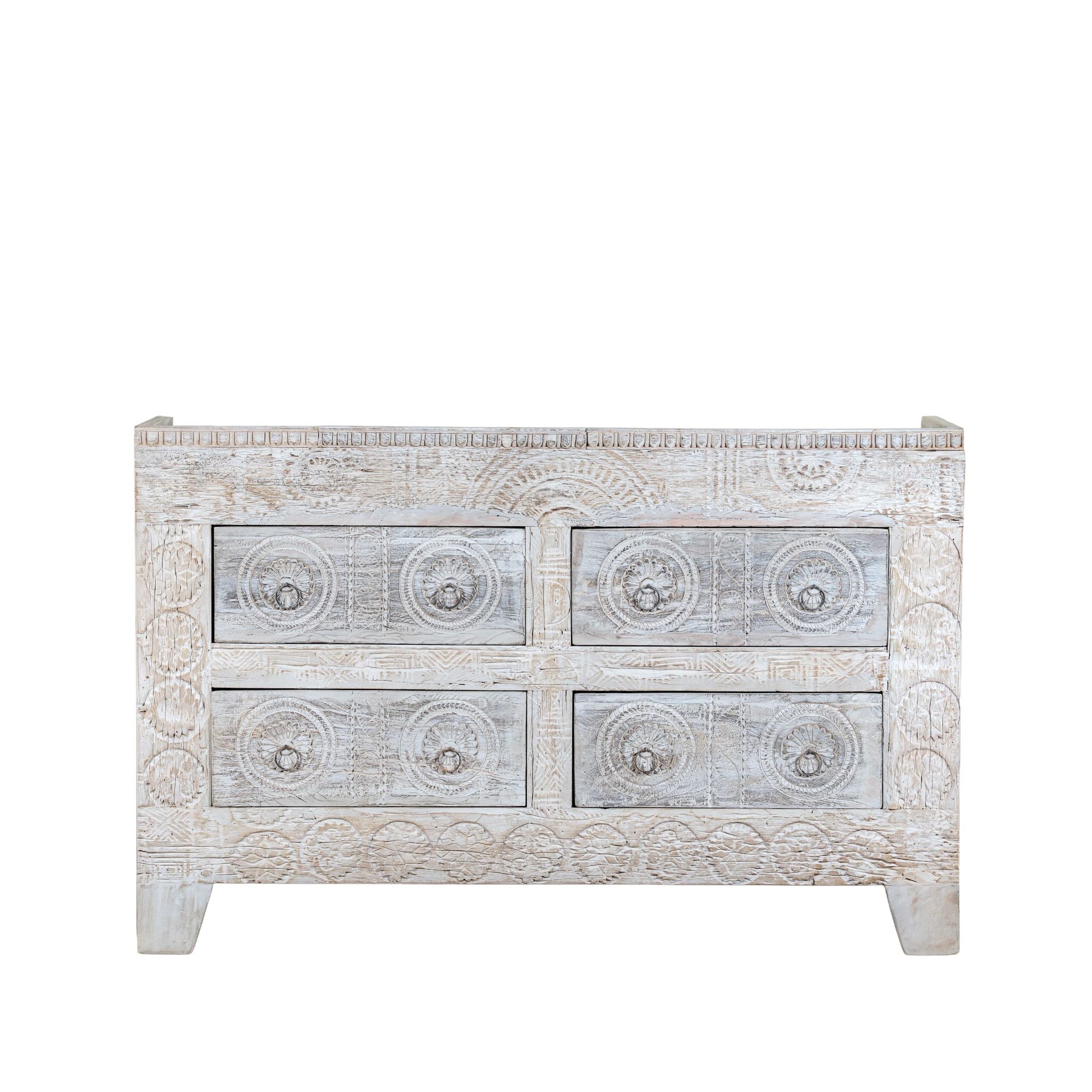 White background image of a handcrafted chest of drawers Zuber made from reclaimed wood, featuring six carved drawers with circular motifs and a whitewashed finish. A rustic, sustainable furniture piece with soft texture and elegant detailing.