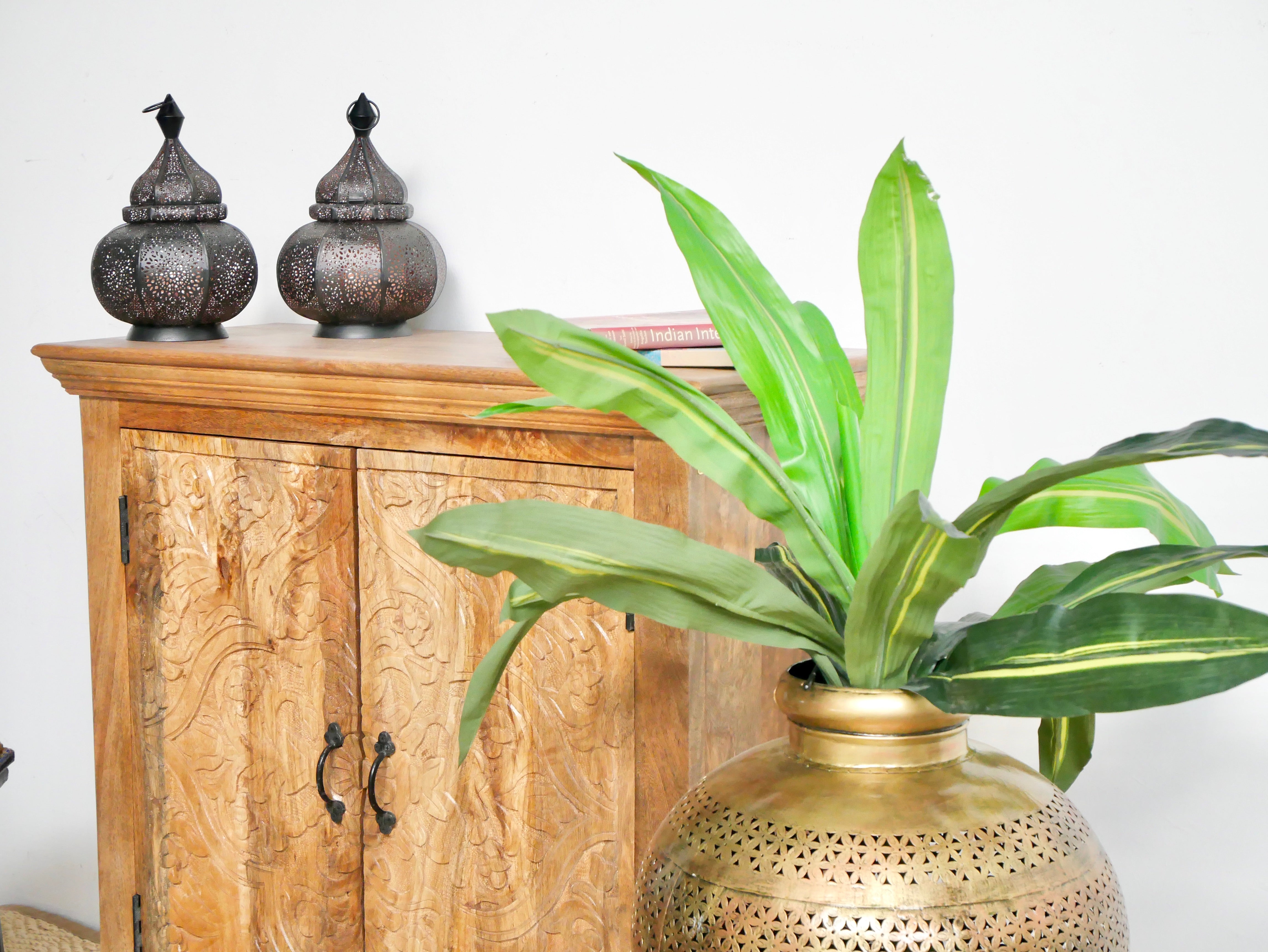 Close up image of a carved wood furniture cabinet made from solid mango wood, hand-carved floral design, Mediterranean-style, 90 × 97 × 40 cm.