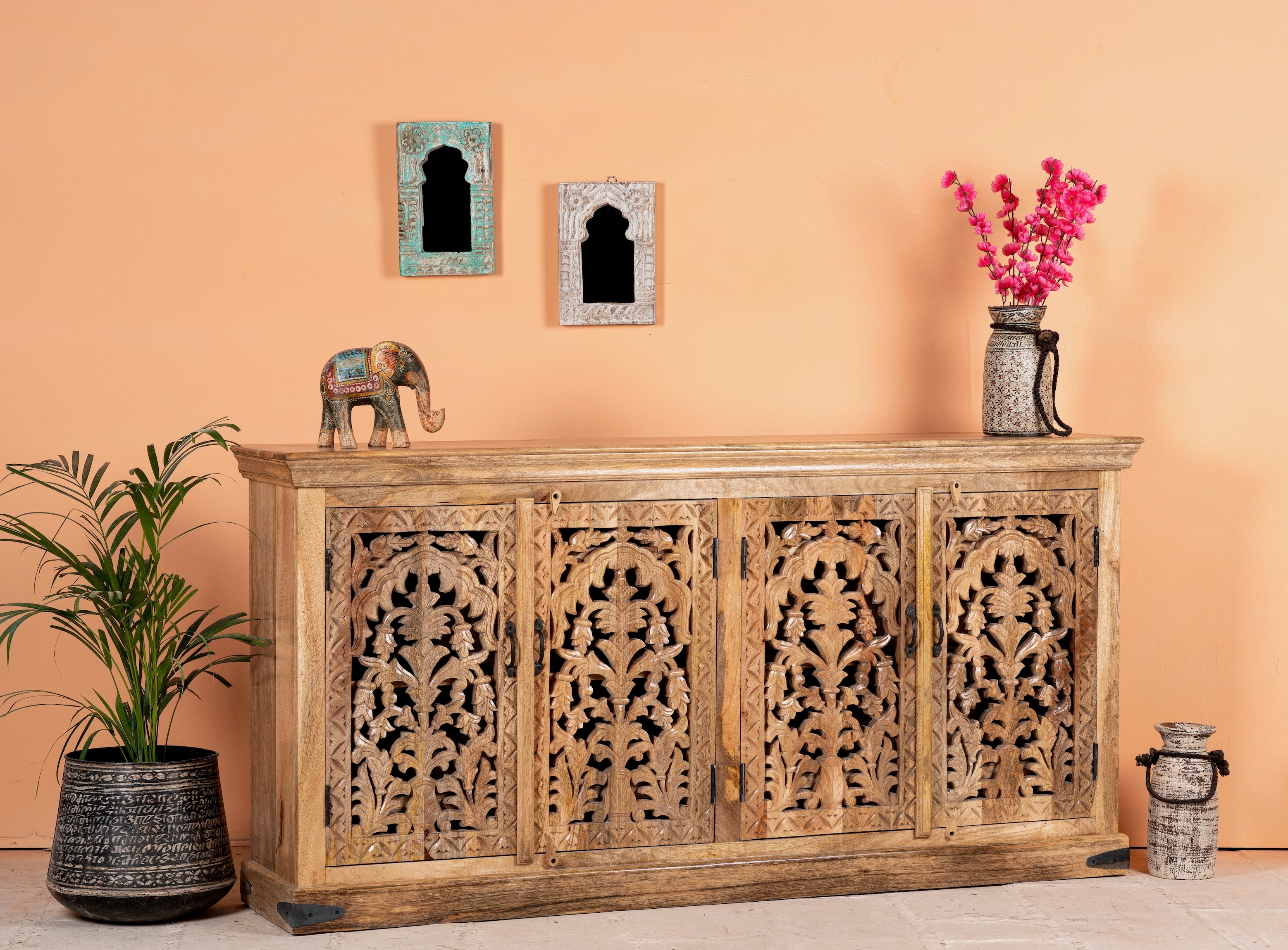 Side angle image of a hand carved mango wood sideboard Bagodara with whitewashed finish and intricate Indian patterns; ideal for bedroom furniture or as a hand carved sideboard, 180 × 90 × 40 cm.