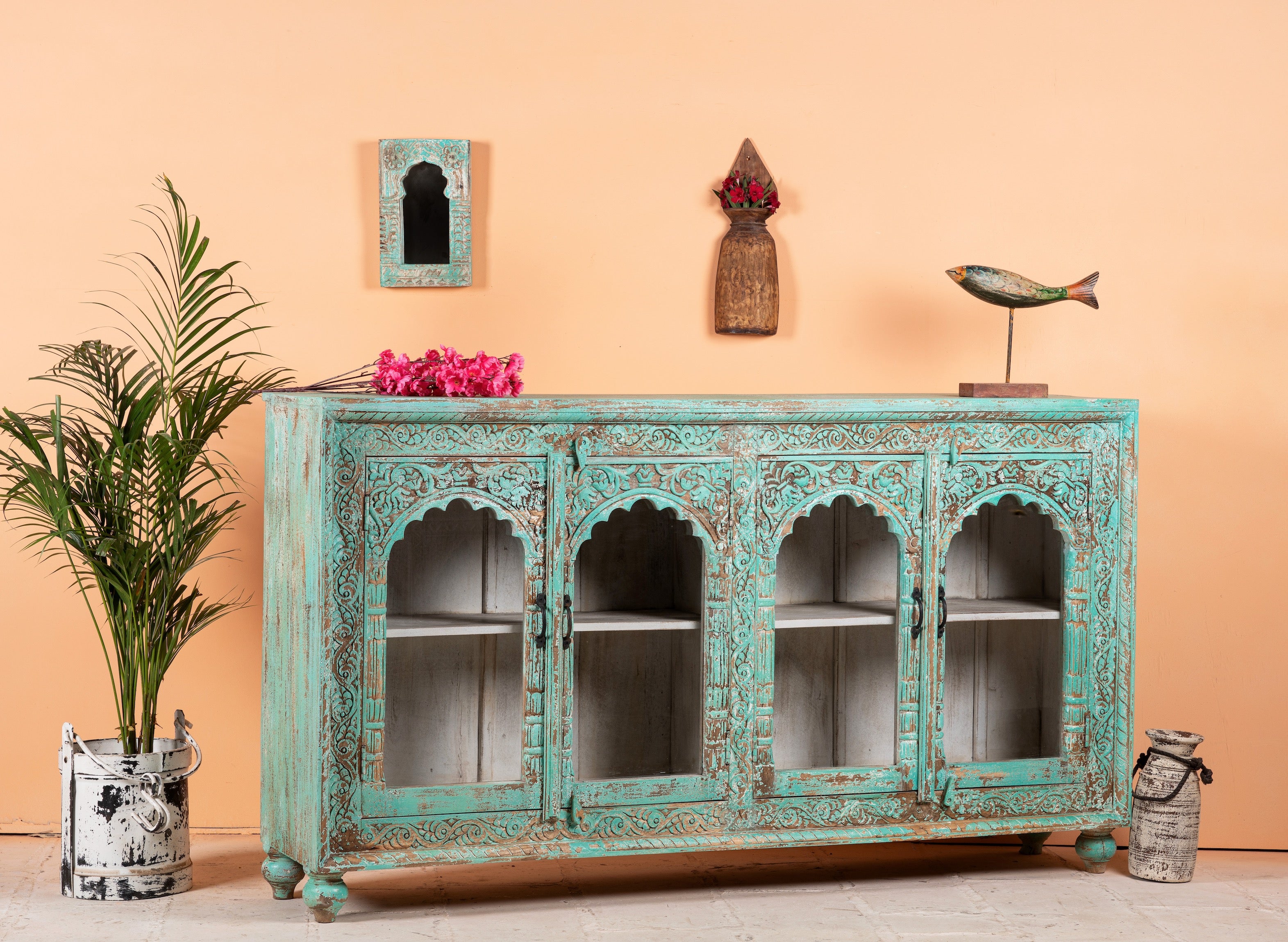 Side angle image of Jesar wood carved sideboard in turquoise finish, a vibrant statement for a boho chic living room.