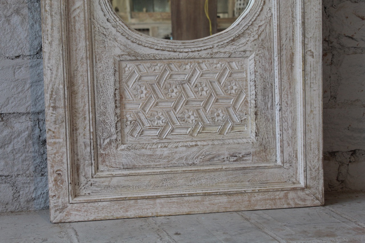 Close up image of a white washed tall vintage wall mirror with hand-carved mango wood frame; rustic hand carved mirror, 86 × 160 × 5 cm.