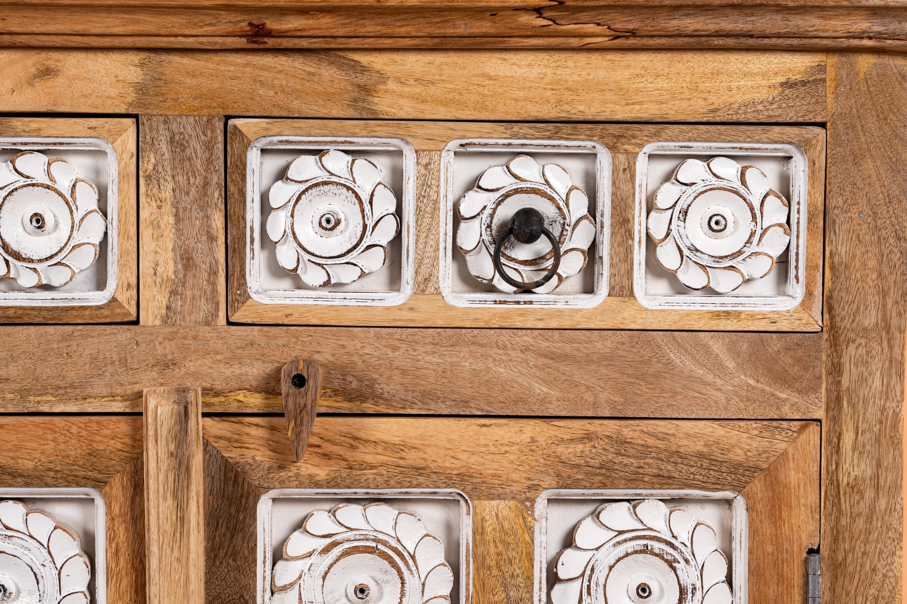 Close up image of a hand-carved mango wood sideboard with whitewashed floral details; perfect as living room furniture or mango wood furniture for vintage interiors, 180 × 100 × 40 cm.