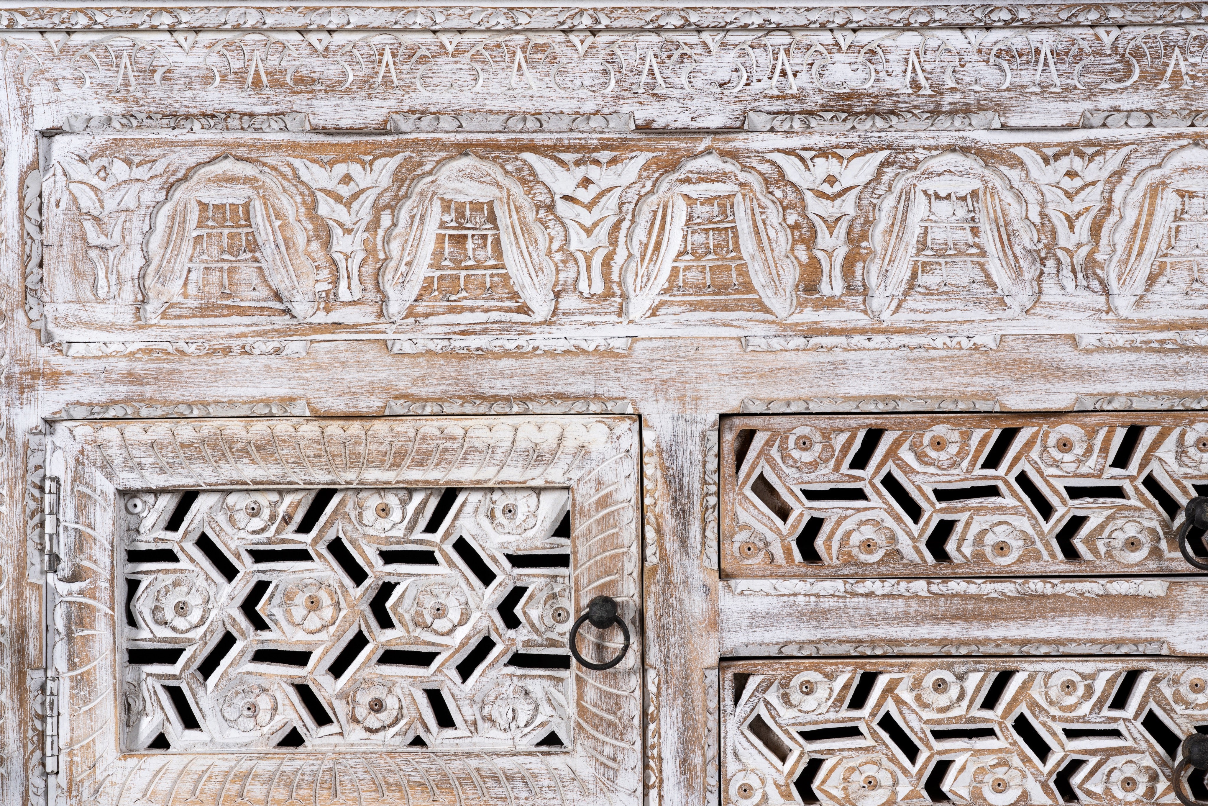 Close up image of a hand-carved wooden sideboard made from solid mango wood with drawers and compartments; unique furniture piece in Mediterranean style, 180 × 100 × 40 cm.
