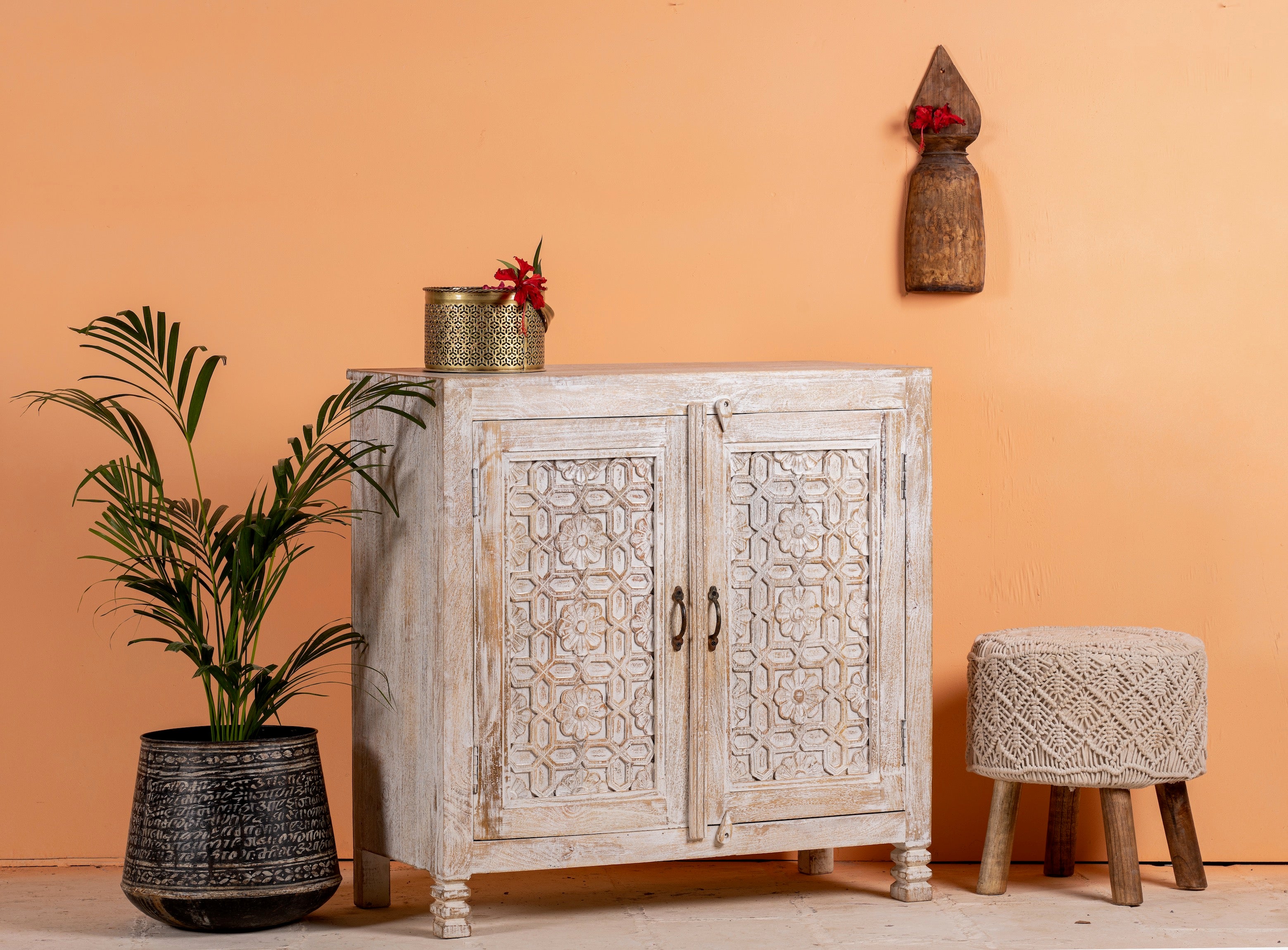 Side angle image of a white washed cabinet handcrafted from mango wood with engraved doors; artisanal Indian mango wood furniture, 90 × 90 × 40 cm.