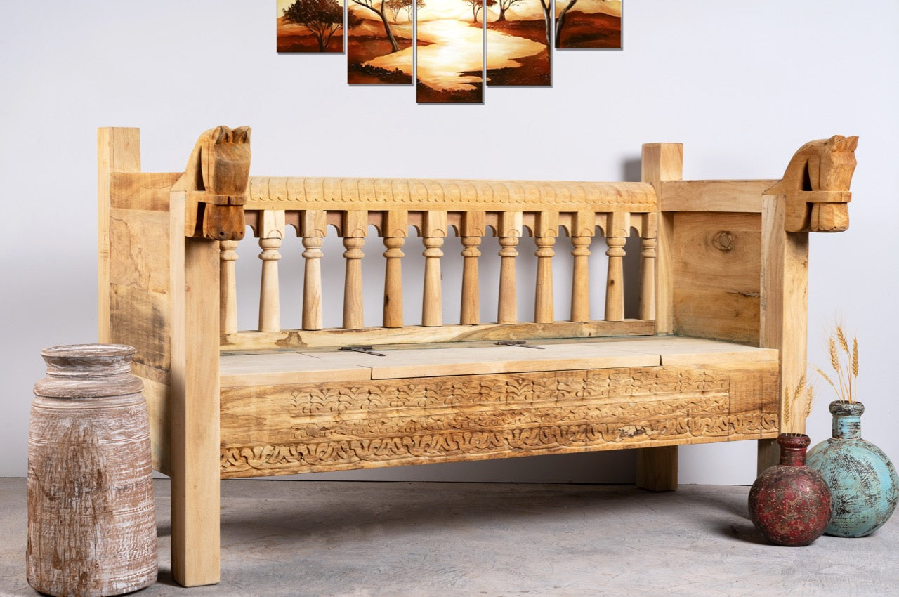 Reclaimed teak wood bench with horse-head carvings and hidden storage; sustainable double-seater with cushion, 150 × 93 × 77 cm.