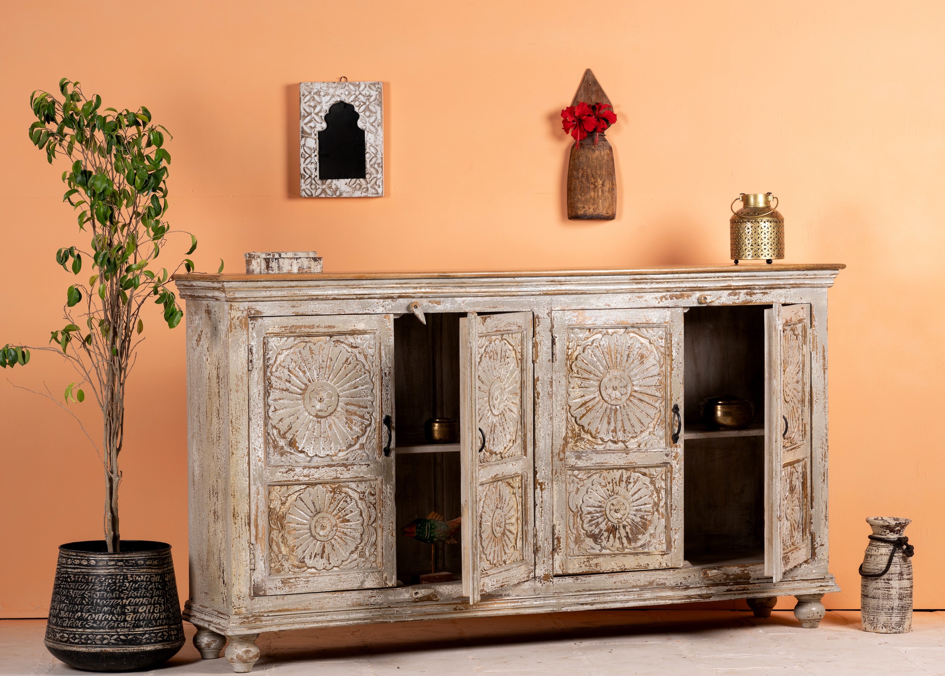 Open door image of a handcrafted carved sideboard made from reclaimed wood with floral motifs and distressed finish; suitable as bedroom furniture, 180 × 40 × 100 cm.