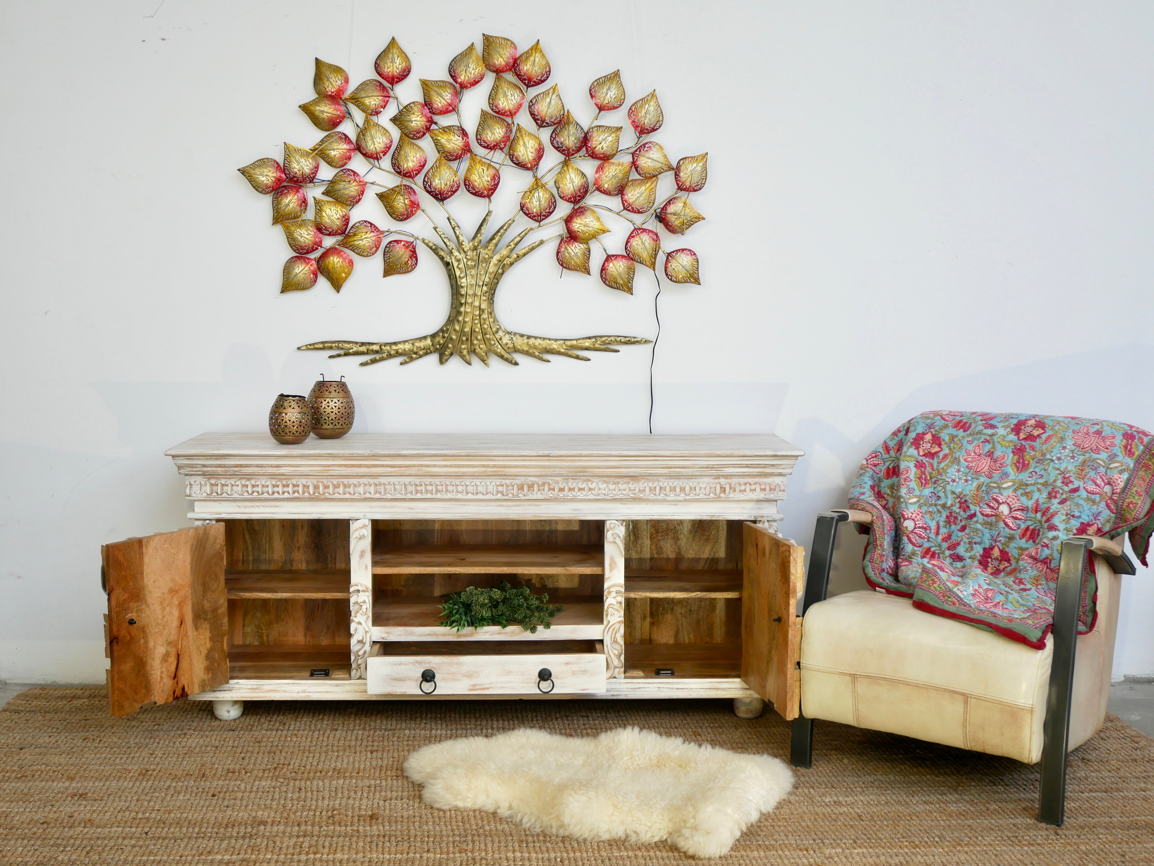 open door image of a Raichur white hand-carved mango wood lowboard with two doors, one drawer, and open shelving; carved wooden sideboard for living or media room, 160 × 75 × 40 cm.
