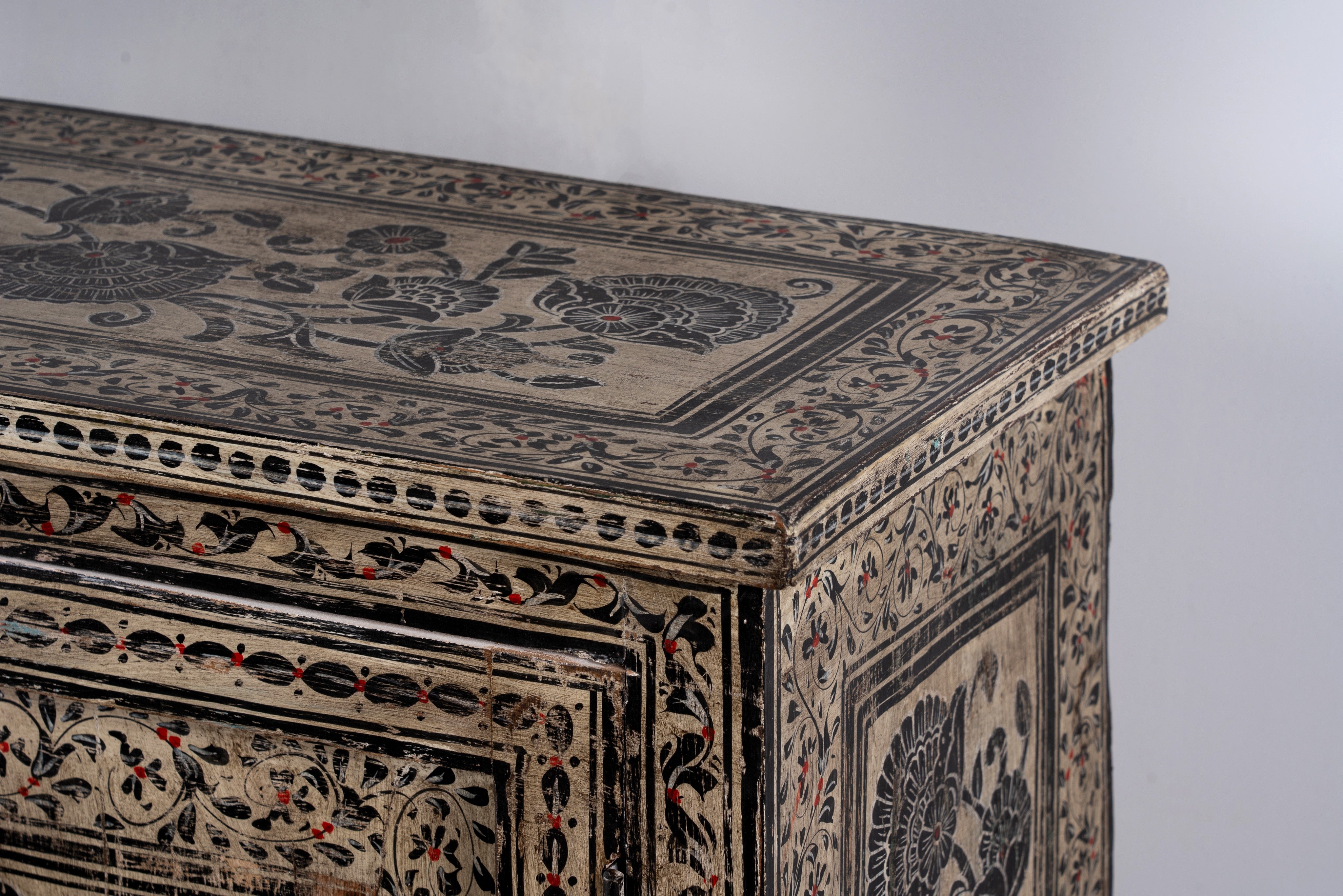 Close up image of a hand-painted cupboard made from reclaimed wood with Indian floral motifs; ideal for boho chic living room or unique furniture decor, 100 × 92 × 36 cm.