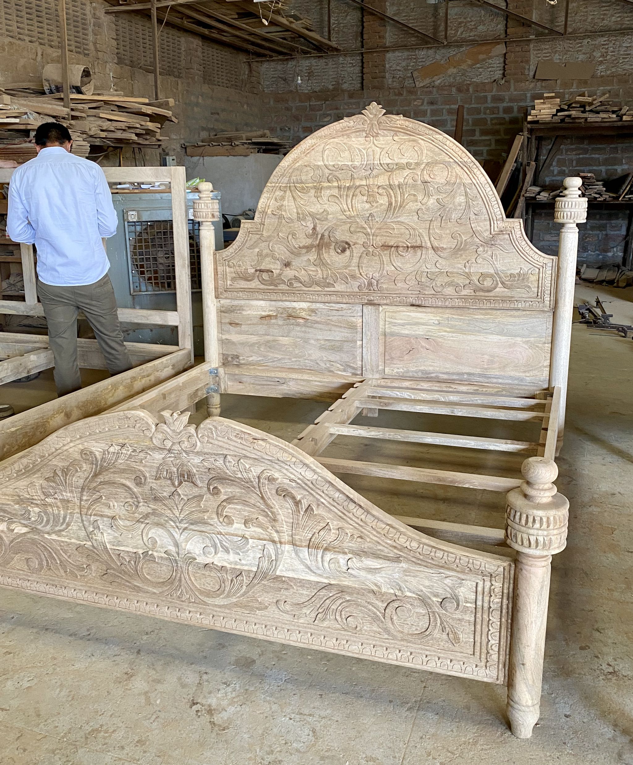 Side angle image of a beautiful hand-carved bed made from solid mango wood. Available in natural or whitewashed finish. Sustainable, artisan-crafted, and full of character.

