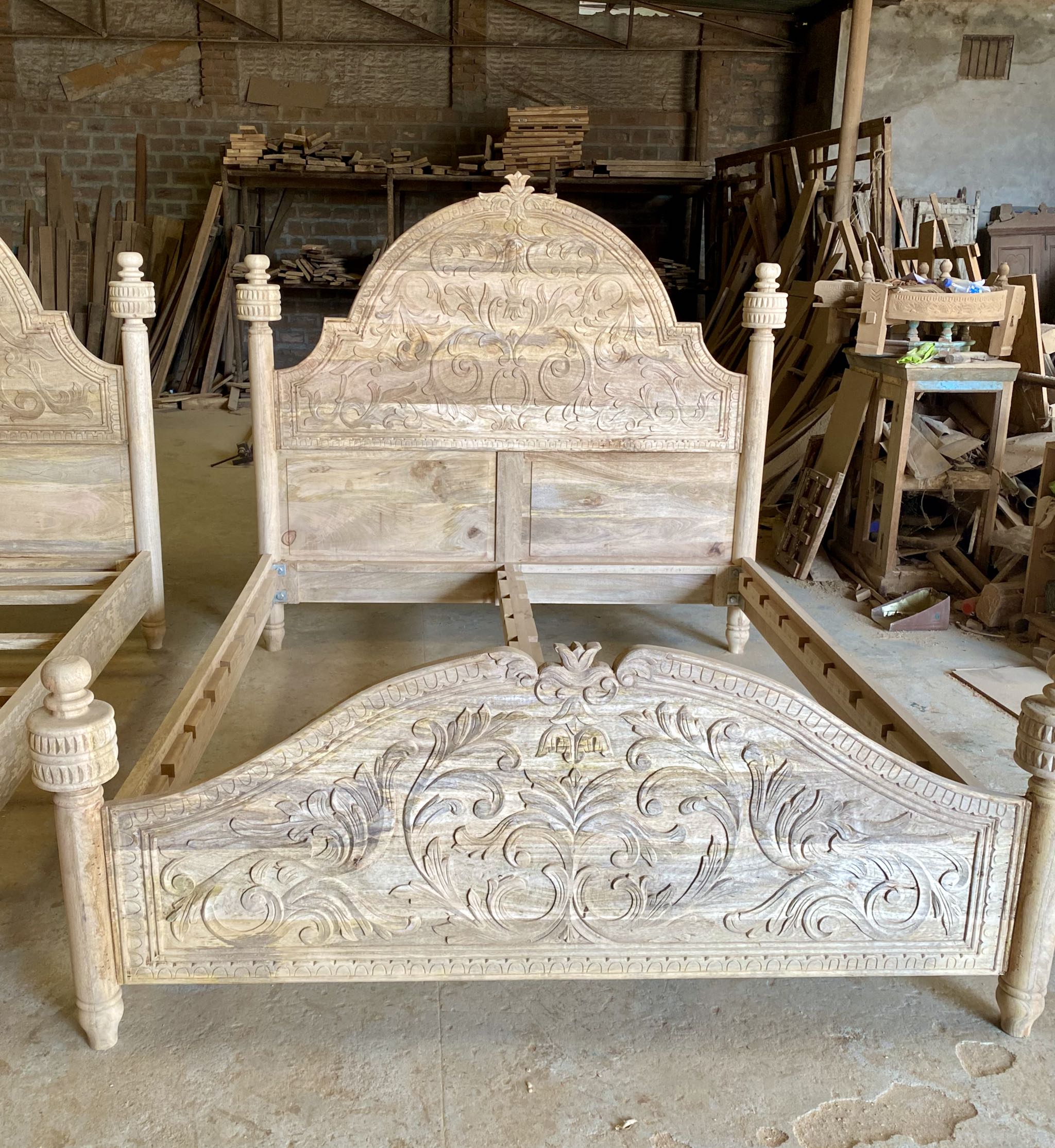 Front image of a beautiful hand-carved bed made from solid mango wood. Available in natural or whitewashed finish. Sustainable, artisan-crafted, and full of character.

