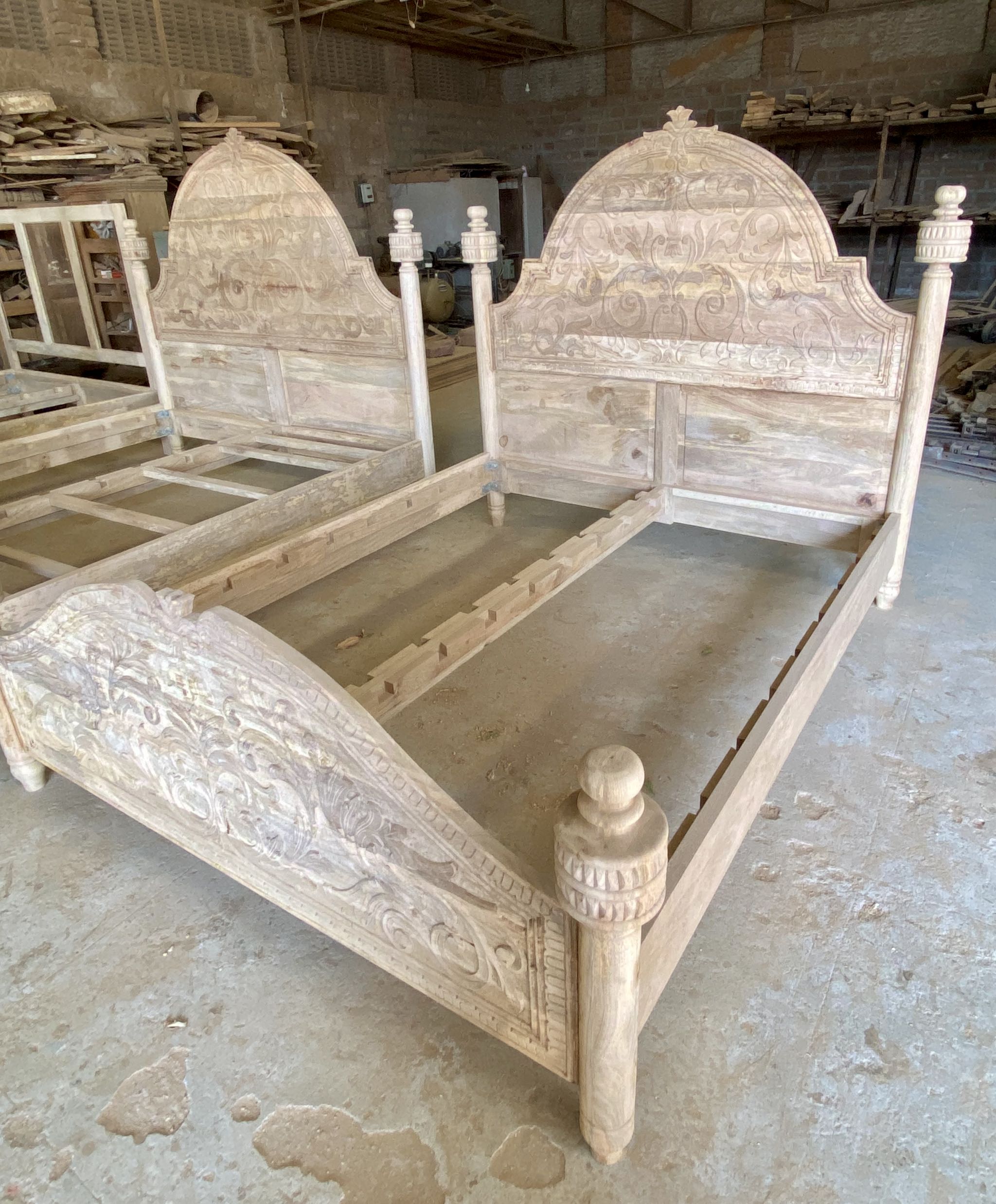 Side angle image of a  180x200cm beautiful hand-carved bed made from solid mango wood. Available in natural or whitewashed finish. Sustainable, artisan-crafted, and full of character.

