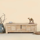 Ibiza style carved mango wood chest with sandblasted finish and iron lock; 150 × 40 × 45 cm.
