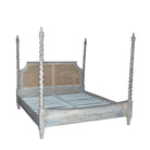 Side angle image of a King-size four-poster bed frame Aadinath made of solid mango wood with hand-carved twisted posts and cane-panel headboard, shown in a natural washed finish; part of a sustainable wooden canopy bed collection.