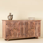 Side view of a sideboard with 4 doors carved with geometrical patterns made of acacia wood.