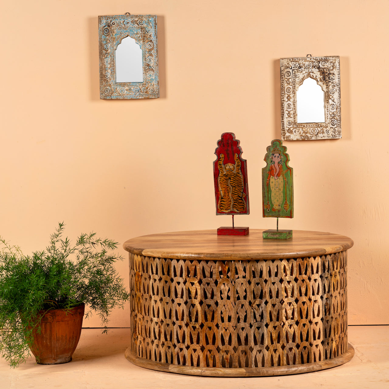 Round mango wood coffee table with hand-carved lattice base and smooth natural top; carved coffee table mango wood, 90 cm diameter, 45 cm height.