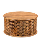 White backround image of a round mango wood coffee table with hand-carved lattice base and smooth natural top; carved coffee table mango wood, 90 cm diameter, 45 cm height.