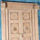 Close up image of a one-of-a-kind antique Indian teak door with sandblasted finish, original brass locks, and reclaimed wood frame extended to European height standards.