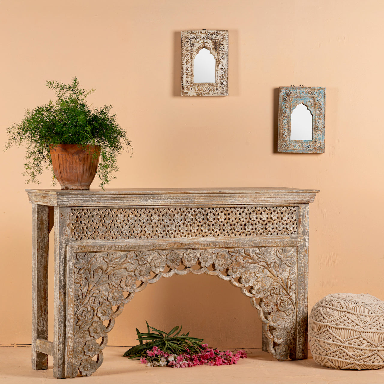 Side angle image of a vintage console table in mango wood with hand-carved floral and geometric patterns and arched detailing; carved console table, 150 × 90 × 40 cm.