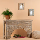 Side angle image of a vintage console table in mango wood with hand-carved floral and geometric patterns and arched detailing; carved console table, 150 × 90 × 40 cm.