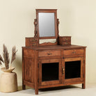 Side angle image of a restored antique cosmetic table in teak wood with hand-carved details; teak wood furniture for bohemian interiors, 105 × 56 × 148 cm.