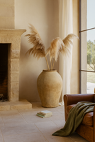 Lifestyle image of an Antique-style Indian clay vase with wide body – a Bali style clay vase perfect for Indian home decoration and boho-inspired interiors.