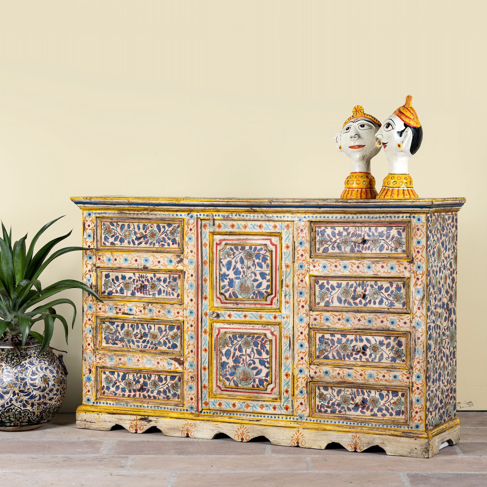 Side angle image of a hand-painted reclaimed wood sideboard with floral motifs – a unique piece of sustainable furniture for vibrant Indian home decor.