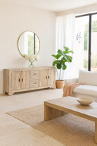 Wooden sideboard sandblasted Ibiza style with multiple doors and drawers in a living room scene.