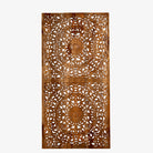 White background image of a hand-carved mango wood wall panel in natural finish with floral designs – Asamanja model by Om Home & Garden
