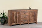 Side angle image of a reclaimed wood sideboard Avika in a rustic minimalistic design with three drawers and two double-door cabinets. A sustainable furniture piece with warm wood tones and black iron handles, perfect for eco-conscious interiors.