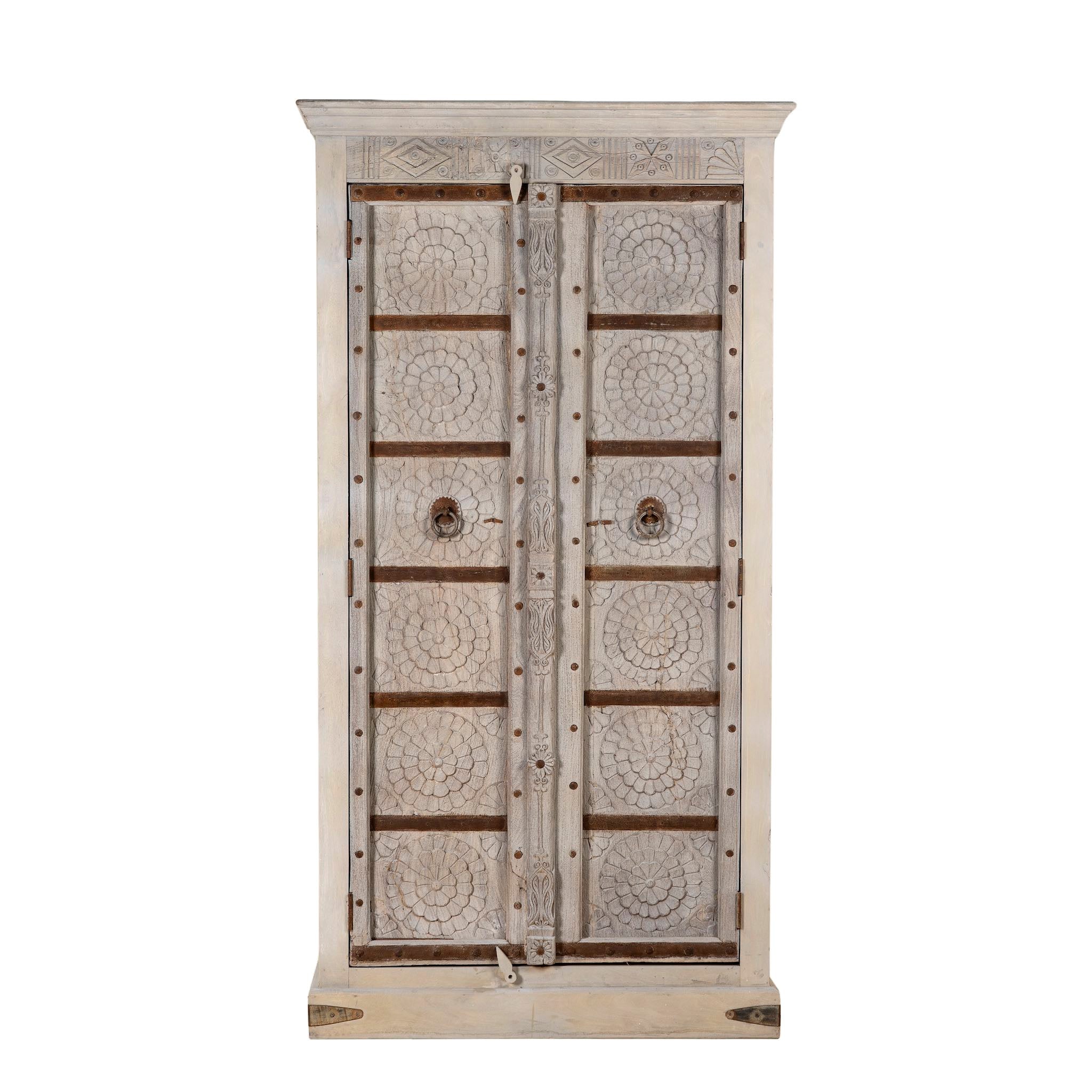 Decorative wooden cabinet with intricate designs on a white background