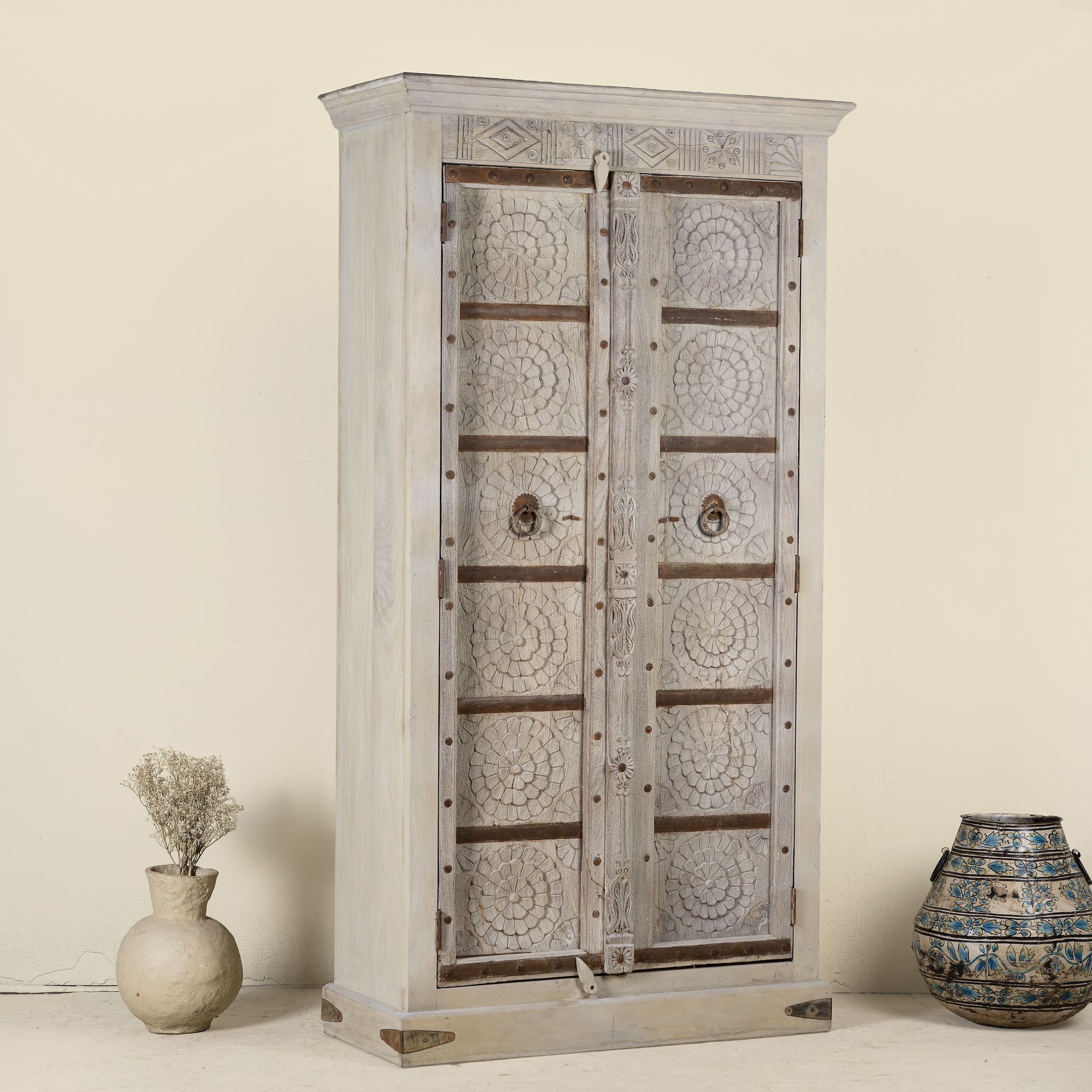Decorative wooden cabinet with intricate patterns on a beige background