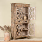 Handcrafted showcase cabinet made from reclaimed wood, featuring diamond-pattern glass pane doors, a crackled paint finish in earthy tones, two drawers, and vintage-inspired detailing.